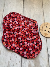 Load image into Gallery viewer, My sanitary towels are made from a top layer of organic cotton jersey that draws the liquid away, the inner core is organic bamboo fleece velour fabric which is highly absorbent, then a layer of PUL which is a breathable waterproof fabric and then of course pretty cotton fabric on the bottom. These high quality, eco friendly fabrics are anti-bacterial, anti-odour and therefore kind to your skin as well as the environment. They are secured with a plastic snap. Washing Instructions - it is best to wash thes