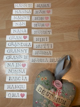 Load image into Gallery viewer, These small hanging hearts are the perfect way to show your love and appreciation to your mum. They look great hung on a wall, door handle or gifted around the neck of a bottle of wine, fizz or bubble bath. They measure approx 13x9cm  Available with any name (hand stamped) and on their own, or in a wicker heart.