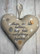 Load image into Gallery viewer, 'Mums are like buttons...they hold everything together' These large hanging hearts look good all year round hung on a wall, on a door handle, or gifted around the neck of a bottle of wine, fizz or bubble bath.   They measure approx. 20x20cm  Available on their own, or in a wicker heart (26x26cm)