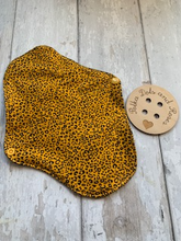 Load image into Gallery viewer, My sanitary towels are made from a top layer of organic cotton jersey that draws the liquid away, the inner core is organic bamboo fleece velour fabric which is highly absorbent, then a layer of PUL which is a breathable waterproof fabric and then of course pretty cotton fabric on the bottom. These high quality, eco friendly fabrics are anti-bacterial, anti-odour and therefore kind to your skin as well as the environment. They are secured with a plastic snap. Washing Instructions - it is best to wash thes