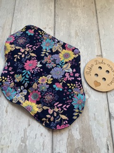 Load image into Gallery viewer, My sanitary towels are made from a top layer of organic cotton jersey that draws the liquid away, the inner core is organic bamboo fleece velour fabric which is highly absorbent, then a layer of PUL which is a breathable waterproof fabric and then of course pretty cotton fabric on the bottom. These high quality, eco friendly fabrics are anti-bacterial, anti-odour and therefore kind to your skin as well as the environment. They are secured with a plastic snap. Washing Instructions - it is best to wash thes