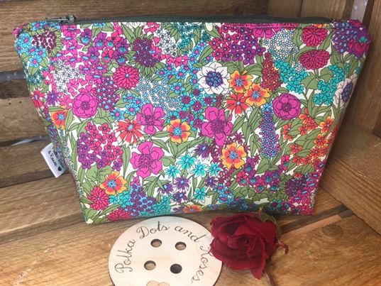 Liberty fabric and waterproof lined wash bag - measuring approx. 25cm along the top, 15cm high and 8cm wide at the base so it can stand up.