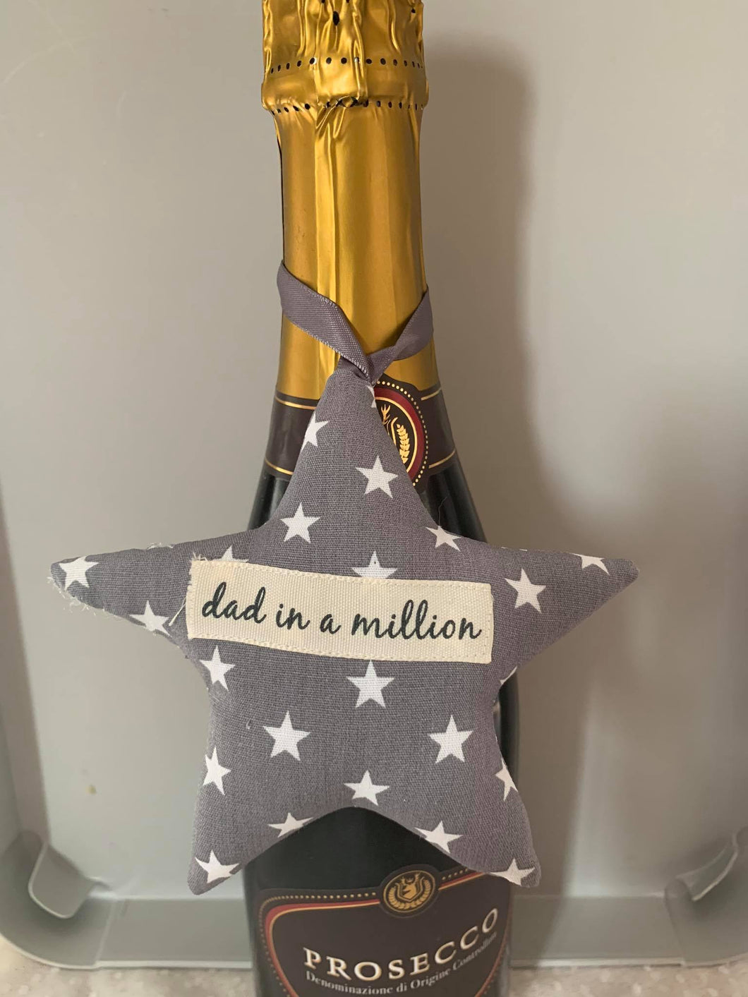 A softly padded star or heart with looped ribbon - so perfect for hanging around the bottle of something when gifting.  They can then choose where to hang it afterwards.  Choose your message - 'Dad in a Million', 'Grandad in a Million' or 'Happy Father's Day'  Fabric options are - grey stars, football, Union Jack or rugby - I have many more options so please use the 'Contact Us' page if you would like to discuss these.