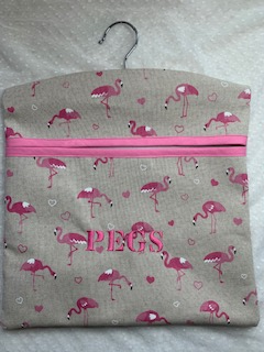My peg bags are made from good quality fabric and have a large open pocket at the front that is strengthened with bias binding. The wooden hanger can swivel so you can hang the bag wherever you need to.  They measure approx. 32 x 30cm so can fit plenty of pegs in.