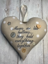 Load image into Gallery viewer, &#39;Mums are like buttons...they hold everything together&#39; These large hanging hearts look good all year round hung on a wall, on a door handle, or gifted around the neck of a bottle of wine, fizz or bubble bath.   They measure approx. 20x20cm  Available on their own, or in a wicker heart (26x26cm)
