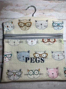 My peg bags are made from good quality fabric and have a large open pocket at the front that is strengthened with bias binding. The wooden hanger can swivel so you can hang the nag wherever you need to.  They measure approx. 32x30cm so can fit plenty of pegs in.